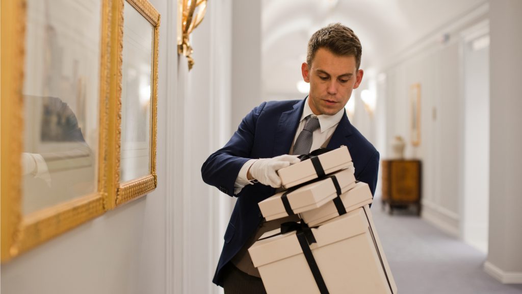 A butler carrying parcels at St. Regis Boston, The Residences.